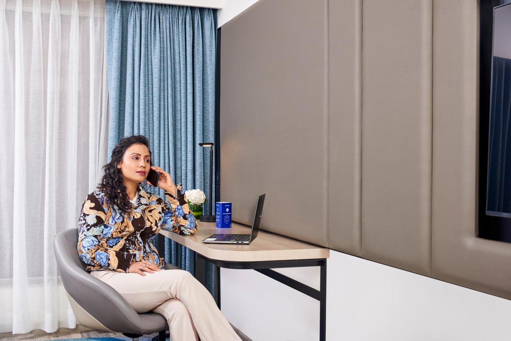 Novotel Mumbai International Airport ภายนอก รูปภาพ A woman working from home